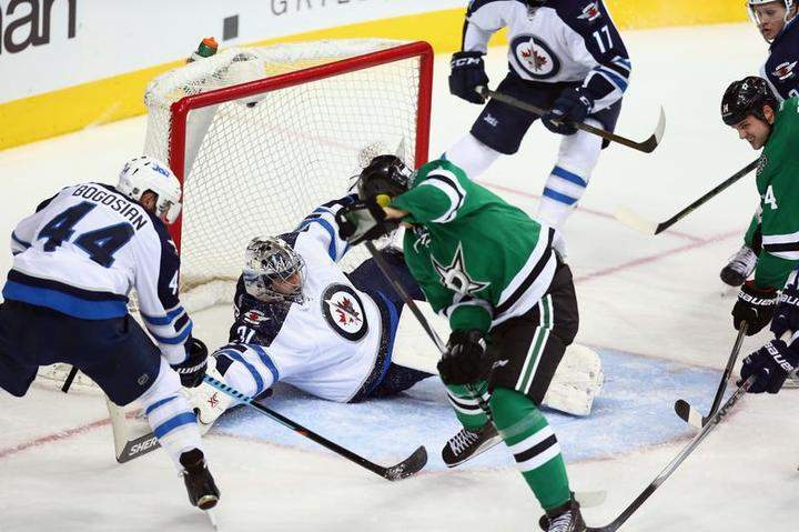 Ondrej Pavelec makes a save in front of Jason Spezza on Jan. 16. The Jets have a 92.4 per cent chance of making the playoffs, according to Sports Club Stats.