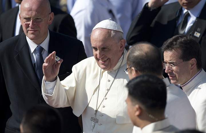 Pope Francis (C) waves to the crowd during a departure ceremony at Villamor Airbase in Manila on January 19, 2015.  Pope Francis flew back to Rome on January 19 after a dramatic week in Asia that saw him draw record crowds and hammer home his pro-poor message to millions.