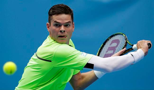 Milos Raonic eyes the ball for a shot to Illya Marchenko of Ukraine during their first round match at the Australian Open tennis championship in Melbourne, Australia, Tuesday, Jan. 20, 2015.