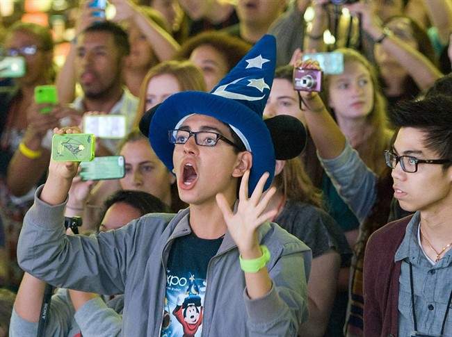 FILE - In this Aug. 2013 file photo, fans attend an event at Disneyland in Anaheim, Calif. Seven Californians and two people in Utah have confirmed cases of measles likely contracted on trips last month to Disney theme parks in California, state officials said Wednesday, Jan. 7, 2015. 