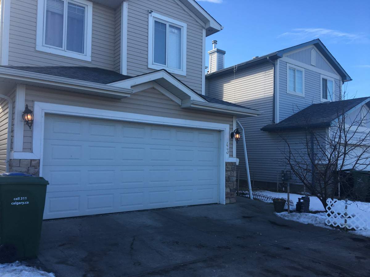 Blood can be seen on the driveway of a northeast Calgary home after a man was reportedly shot on Saturday evening, Sunday, Jan. 26, 2020.