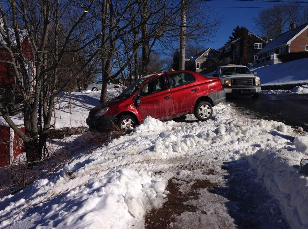 A second vehicle is flattened by a garbage truck.