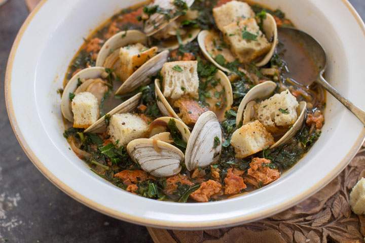 This Jan. 5, 2015 photo shows spicy clam and kale soup in Concord, N.H. Tucked away between the tofu “cheeses” and textured vegetable protein taco crumbles lies a good go-to and good-for-you ingredient, soy chorizo.