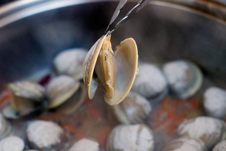 This Jan. 5, 2015, photo shows the making of clams and bok choy with black bean sauce in Concord, N.H. Clams are lean and delicious source of protein and the automatic generator of a tasty, instant sauce.