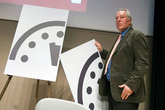 Climate scientist Richard Somerville, a member, Science and Security Board, Bulletin of the Atomic Scientists, unveils the new Doomsday Clock in Washington, Thursday, Jan. 22, 2015.