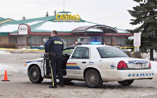 Police contain the scene where two RCMP officers were shot in St. Albert, Alta., on Saturday, January 17, 2015. 