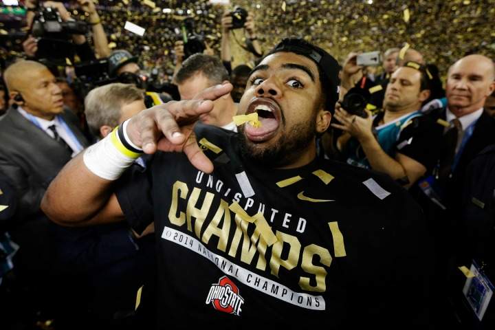 Ohio State's Ezekiel Elliott celebrates after the NCAA college football playoff championship game against Oregon Monday, Jan. 12, 2015, in Arlington, Texas. Ohio State won 42-20.