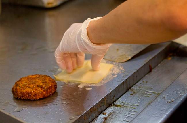 File photo shows a burger being grilled. 