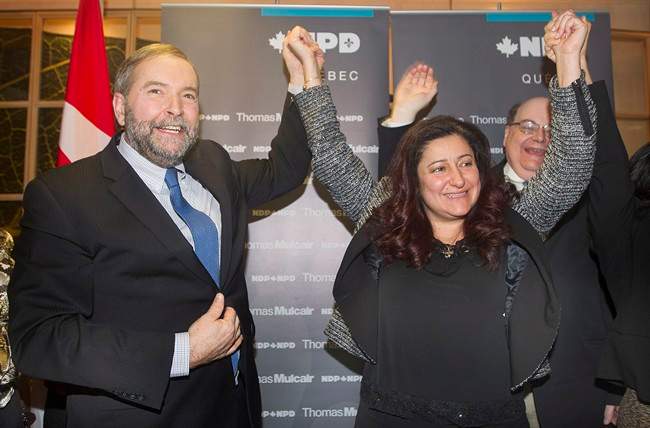 NDP leader Thomas Mulcair raises the hand of Maria Mourani in Montreal, Wednesday, January 21, 2015, where he announced that she would run as an NDP candidate in the riding of Ahuntsic-Cartierville in the upcoming federal election.