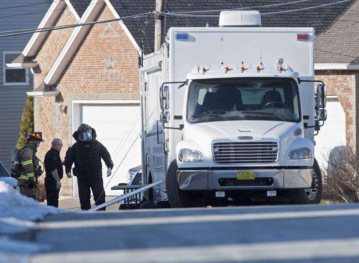 A member of the RCMP explosive disposal unit prepares to enter a residence in Cole Harbour, a Halifax suburb, on Tuesday, Jan. 20, 2015.