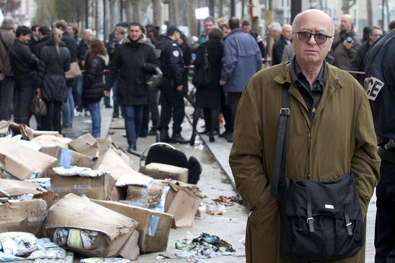 French cartoonist Georges Wolinski stands in front of the offices of French satirical magazine ‘Charlie Hebdo’ following a petrol bomb attack on November 2, 2011 in Paris, France.