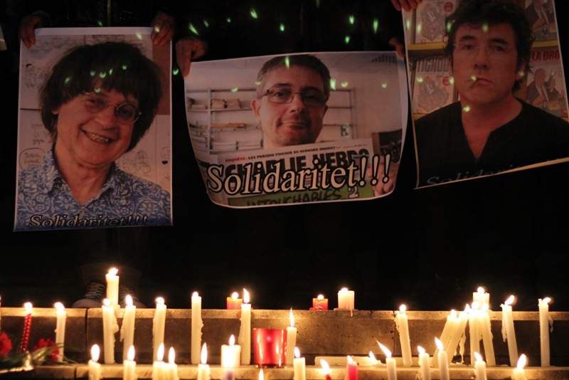 Albanian journalists hold pictures of French satirical weekly Charlie Hebdo's cartoonists (From L) Jean Cabut aka Cabu, Charb and Tignous during a gathering in solidarity with the victims of the terror attack at Charlie Hebdo in Paris earlier today, in Tirana on January 7, 2015. 