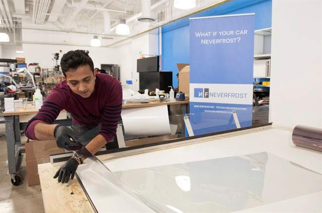 Neverfrost co-founder Khanjan Desai works in Kitchener, Ont., on Friday, Dec. 12, 2014 with an infrared-reflective film he and his co-founder Chong Shen created. 