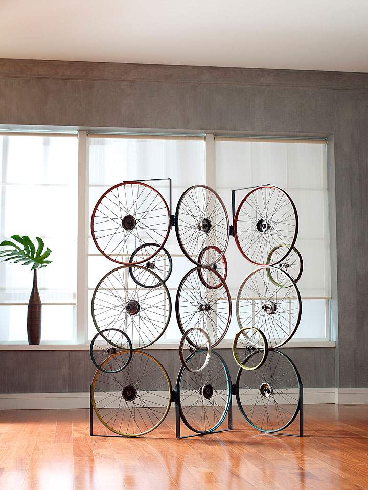 This photo provided by Phillips Collection shows The Bicycle Collection, created by upcycling discarded bicycle rims, pedals and frames. The result are rustic yet sophisticated designs that are instantly recognizable as repurposed. The Bicycle Screen is made from three panels that are hinged together, allowing for many configurations.