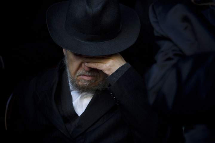 A relative of French Jew Yoav Hattab, a victim of the attack on kosher grocery store in Paris, attends his funeral procession in the city of Bnei Brak near Tel Aviv, Israel, Tuesday, Jan. 13, 2015.