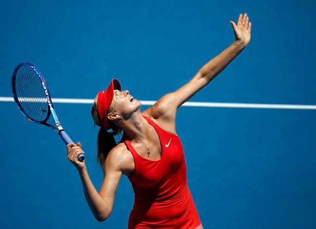 Maria Sharapova of Russia serves to her compatriot Ekaterina Makarova during their semifinal match at the Australian Open tennis championship in Melbourne, Australia, Thursday, Jan. 29, 2015. (AP Photo/Vincent Thian).