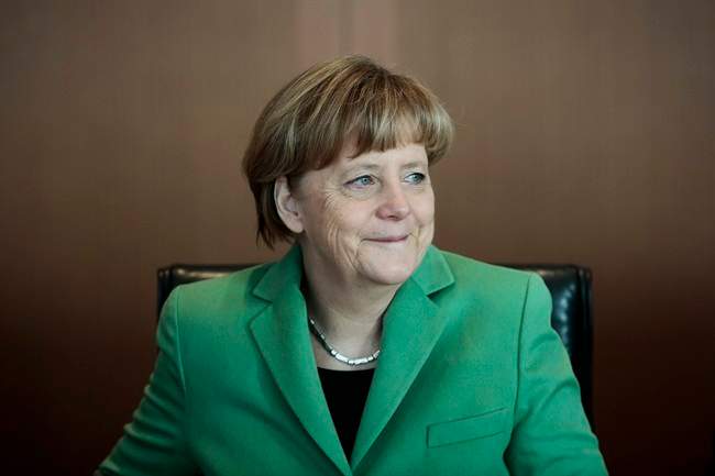German Chancellor Angela Merkel smiles at the beginning of the weekly cabinet meeting of her government at the chancellery in Berlin, Wednesday, Jan. 28, 2015.