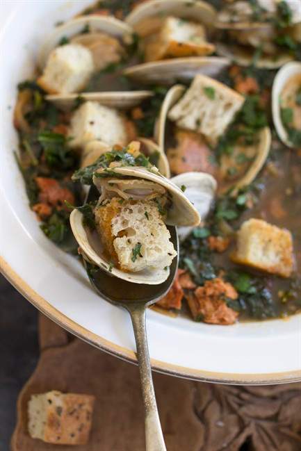 This Jan. 5, 2015 photo shows spicy clam and kale soup in Concord, N.H. Tucked away between the tofu “cheeses” and textured vegetable protein taco crumbles lies a good go-to and good-for-you ingredient, soy chorizo.