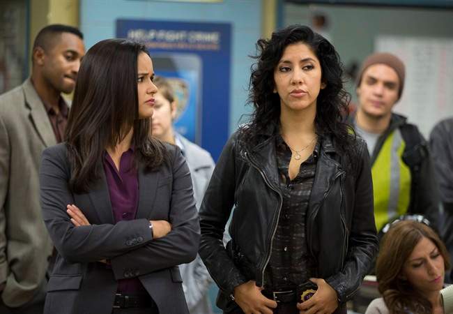 In this image released by Fox, Melissa Fumero, left, and Stephanie Beatriz appear in a scene from the comedy series, "Brooklyn Nine-Nine.".