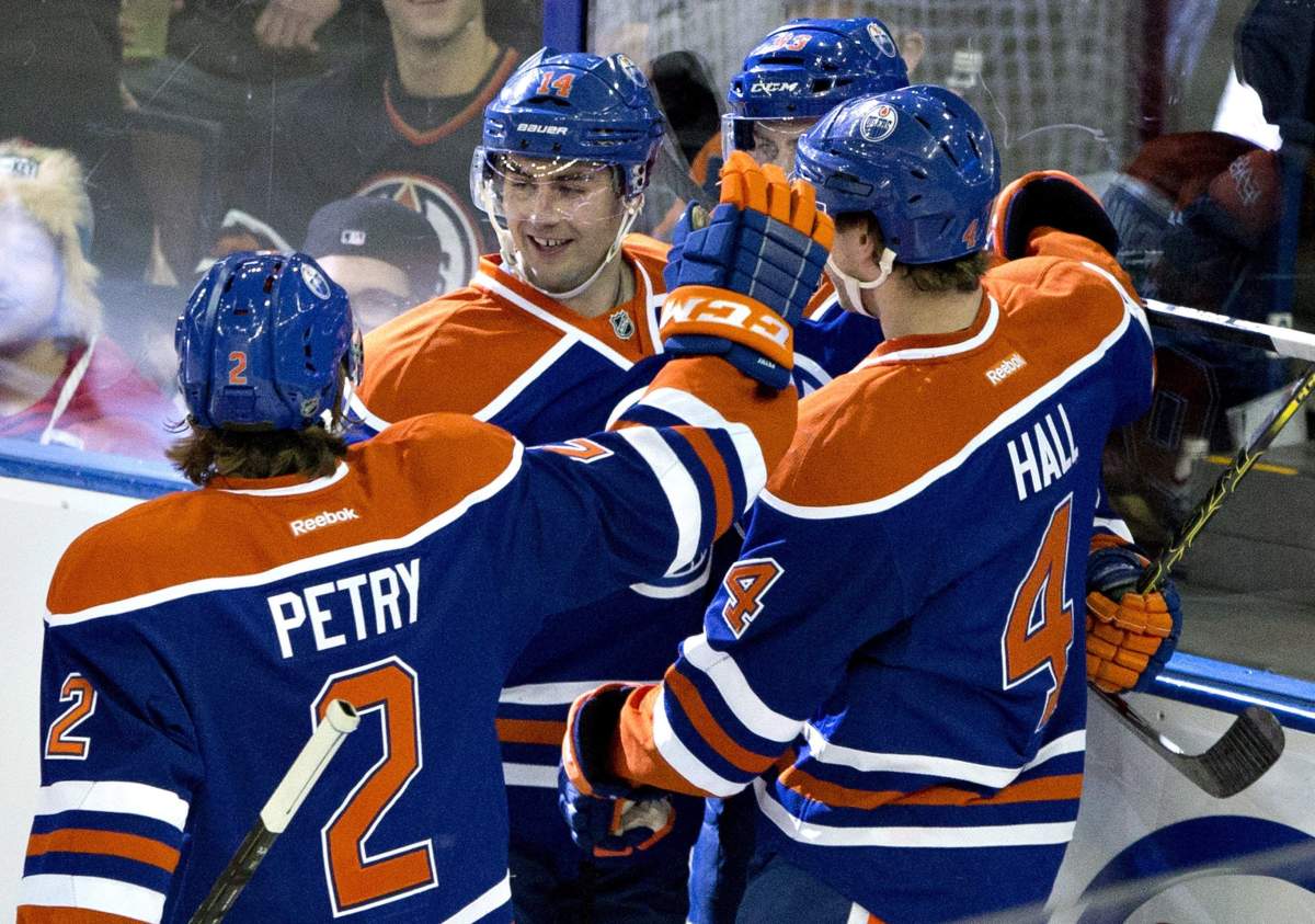 Edmonton Oilers Jeff Petry (2), Jordan Eberle (14) and Taylor Hall (4) celebrate a goal against the New York Islanders during second period NHL hockey action in Edmonton, Alta., on Sunday January 4, 2015.