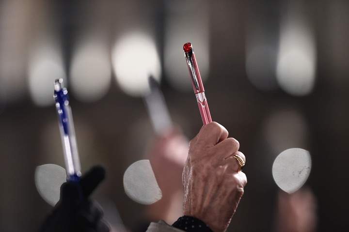 People hold up pens during a gathering in front of the city hall of Rennes, western France, on January 7, 2015, following an attack by unknown gunmen on the offices of the satirical weekly, Charlie Hebdo.