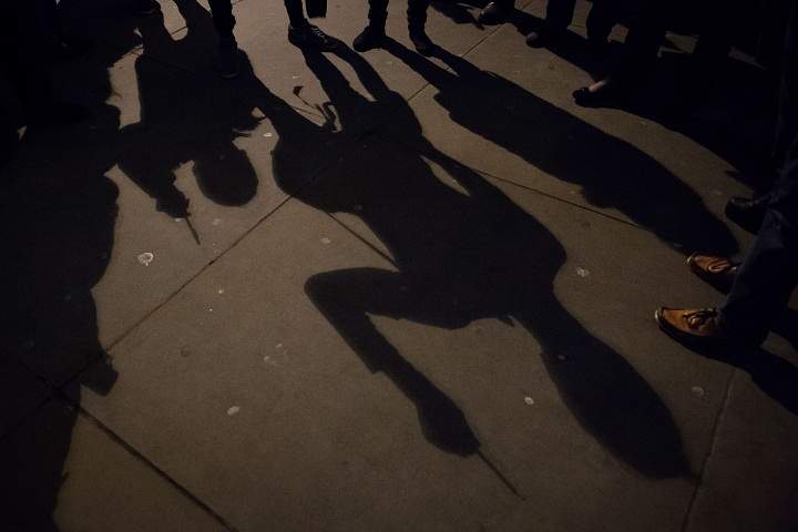 Shadows of people holding pens in the air at a gathering in Trafalgar Square in central London to show their respect for the twelve people killed in Paris today in a terrorist attack at the headquarters of satirical publication “Charlie Hebdo” on January 7, 2015.