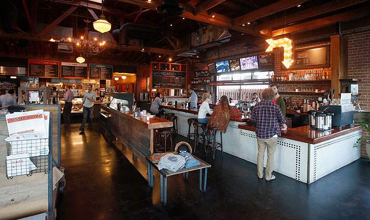 In this Jan. 14, 2015 photo, diners are served at the counter at the Phoenix Public Market Cafe restaurant in Phoenix. The Super Bowl takes place Feb. 1 in nearby Glendale, Ariz., and the restaurant scene in downtown Phoenix sees the game as an opportunity to show off its creative local cuisine.