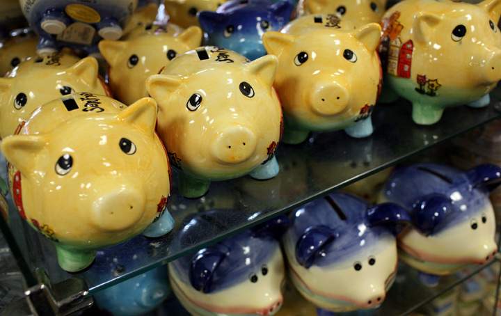 Piggy banks sit on a shelf