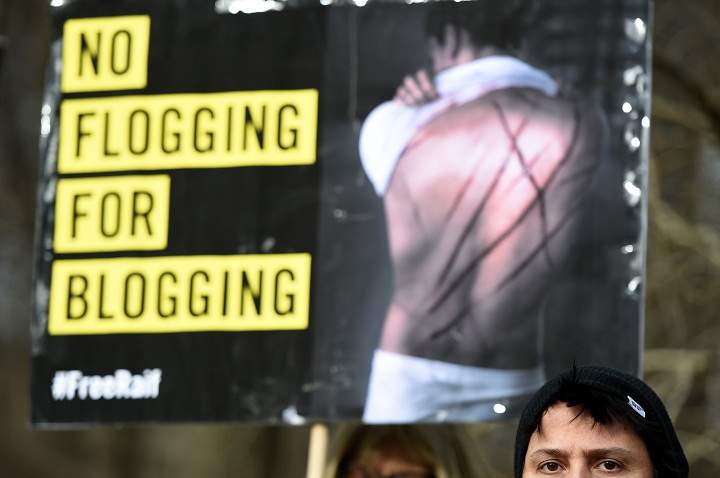 Amnesty International activists protest with a placard reading ‘No flogging for blogging’ against the flogging punishment of Saudi blogger Raif Badawi on January 29, 2015.