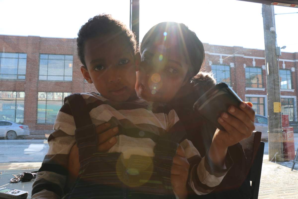 Jillanne Mignon with her son Michael, 6. Mignon had to quit her job because she couldn't afford to pay for child care. Now she's back at school thanks to government funding and extreme juggling.