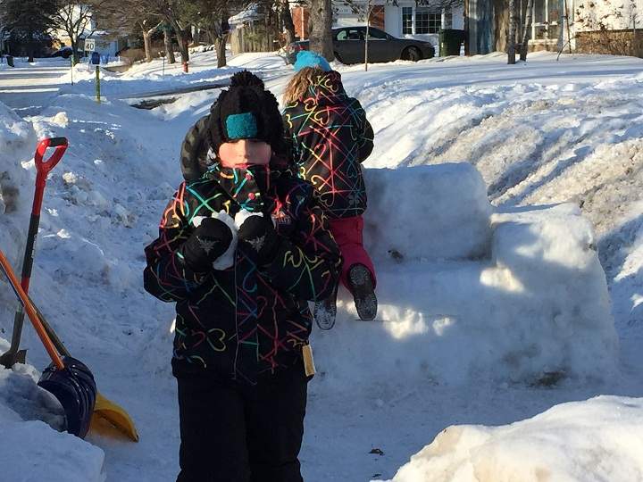 Children play in the Beaconsfield snow fort that city officials are asking to be removed or moved for safety reasons.