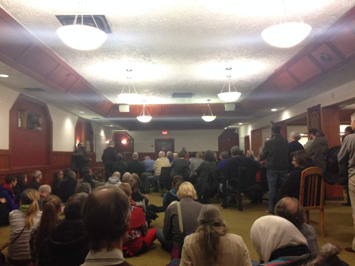 Dozens gather for a vigil honouring the Paris vicitms at Central Mosque Friday night.