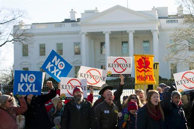 Demonstrators stand in front of the White House during a rally in support of President Barack Obama's pledge to veto any legislation approving the Keystone XL pipeline.
