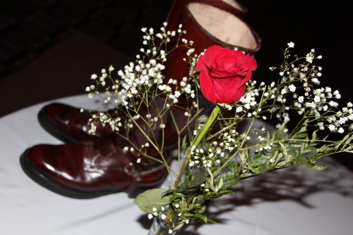 Flowers sit on a table next to a pair of RCMP boots for a memorial for RCMP Const. David Wynn.