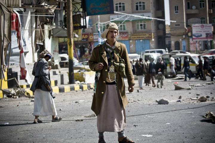 Houthi Shiite Yemeni gather while guarding a street leading to the presidential palace in Sanaa, Yemen, on Tuesday.