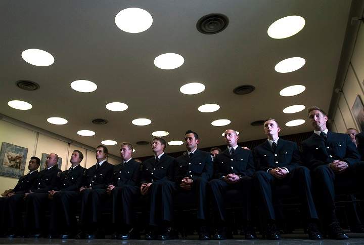 Firefighter graduates march in unison after receiving their badge and certificates during a graduation ceremony at the Toronto Fire/EMS Training Centre in Toronto on Thursday, July 31, 2014. 