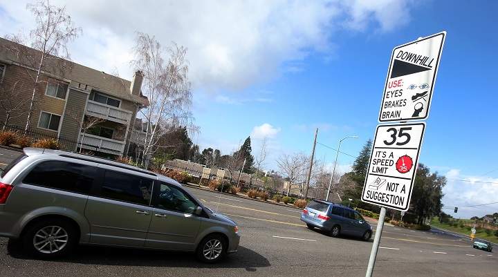 In this Feb. 9, 2015 photo, a new traffic sign sits along Hayward Boulevard in Hayward, Calif. The city is using humor to get drivers to slow down and pedestrians to pay attention.