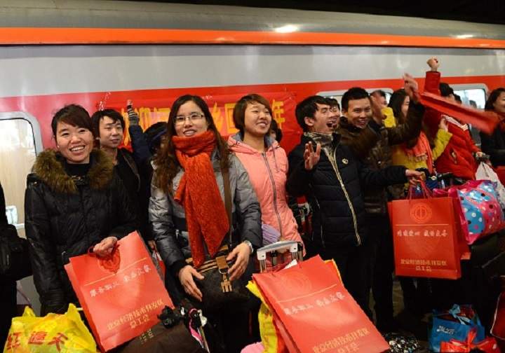 Migrant workers board the first Migrant Labours’ Train to home during the Spring Festival Travel Peak on February 13, 2015 in Beijing, China.