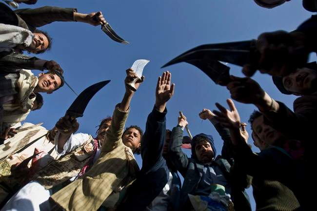 Supporters of Houthi Shiites wave traditional daggers and dance as they celebrate the fourth anniversary of the uprising in Sanaa, Yemen, Wednesday, Feb. 11, 2015. 