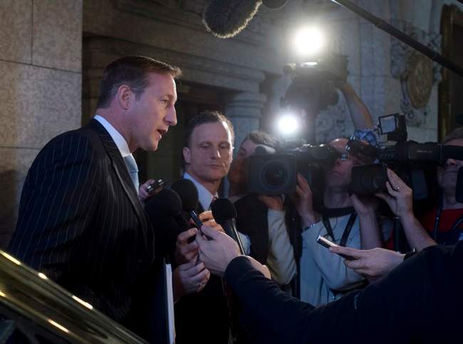 Justice Minister Peter MacKay speaks with the media following question period outside the House of Commons on Parliament Hill in Ottawa on Friday, February 6, 2015. 