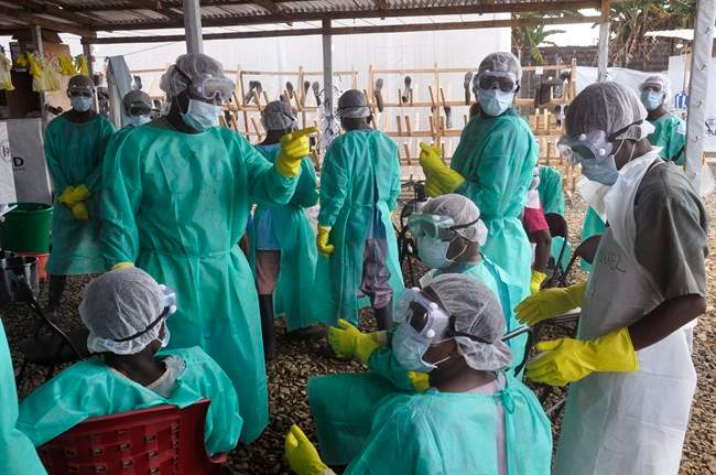Health care workers inside a USAID, funded Ebola clinic with their Ebola virus protective gear in Monrovia, Liberia, Friday, Jan. 30, 2015.