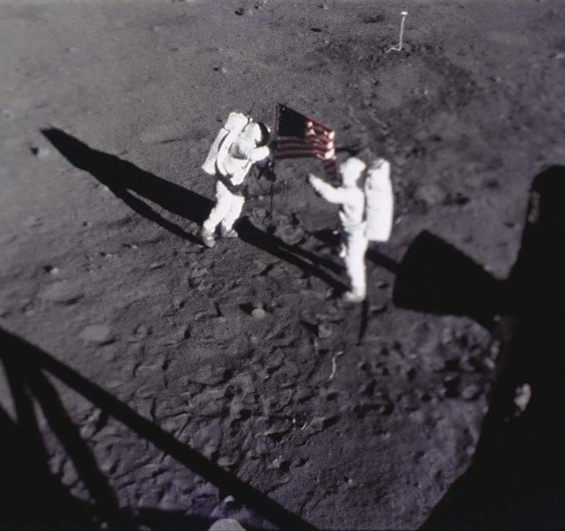 Camera view of Neil and Buzz setting the American Flag