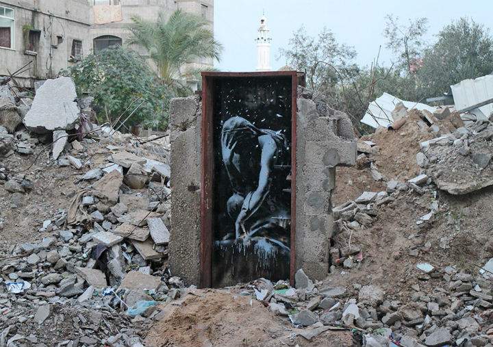 Banksy painted artwork amid the rubble left after Israeli bombings during the summer of 2014.