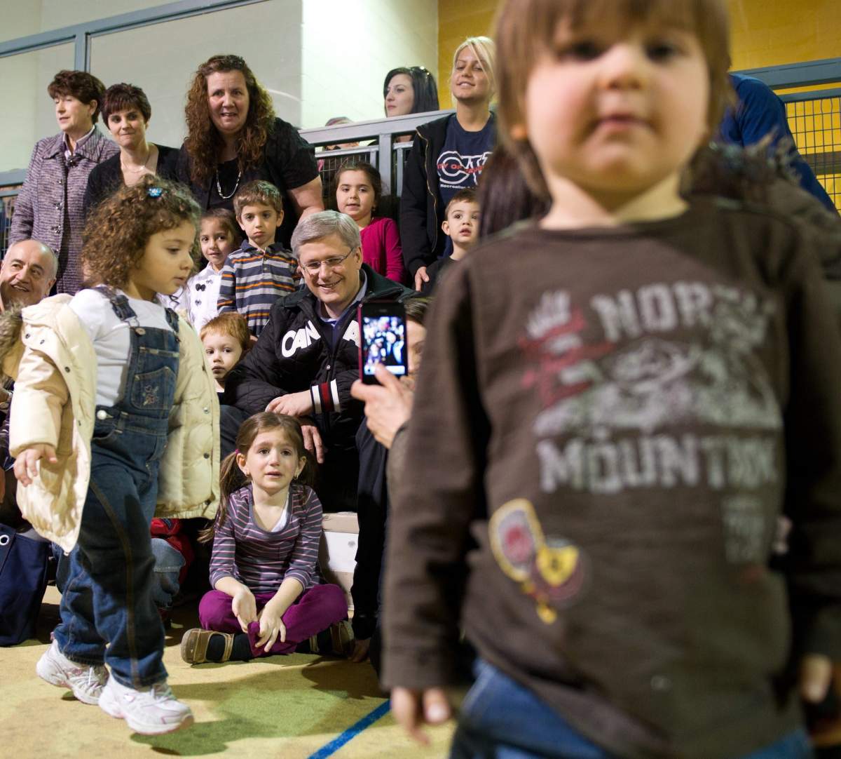Prime Minister Stephen Harper poses with pre-school children from a daycare at the Chancellor Community Centre in Vaughan, Ont., on Thursday, April 7, 2011.