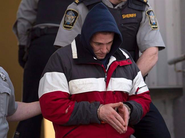 Christopher Burton Phillips is escorted from provincial court in Dartmouth, N.S. on Friday, Jan. 23, 2015.