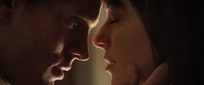 Jamie Dornan, left, and Dakota Johnson appear in a scene from "Fifty Shades of Grey" in this image released by Universal Pictures and Focus Features. THE CANADIAN PRESS/AP-Universal Pictures and Focus Features.