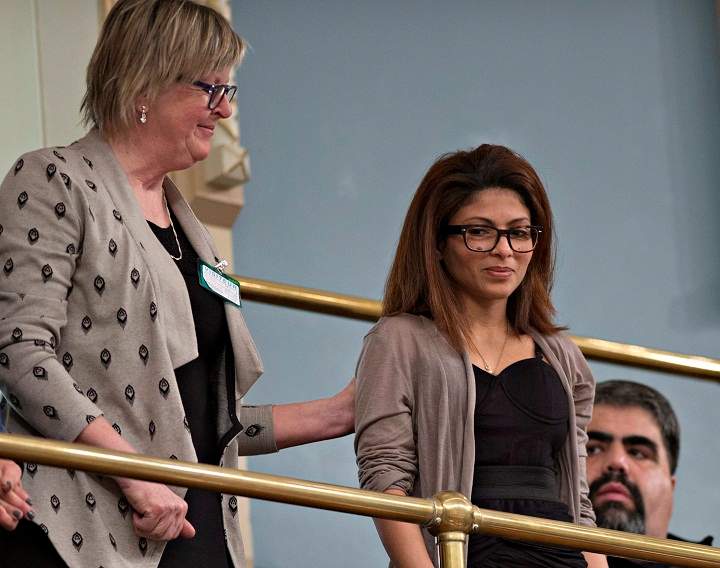 Ensaf Haider, right, wife of Raif Badawi, is comforted by an unidentified woman, after the legislature voted unanimously in favour of a motion to free her husband from a Saudi Arabian jail, during question period Wednesday, February 11, 2015 at the legislature in Quebec City.