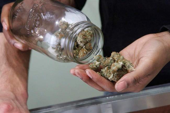In this Feb. 20, 2015 photo, Alaska Cannabis Club CEO Charlo Greene prepares to roll a joint at the medical marijuana dispensary in Anchorage, Alaska. On Tuesday, Feb. 24, 2015, Alaska will become the third state in the nation to legalize marijuana. 