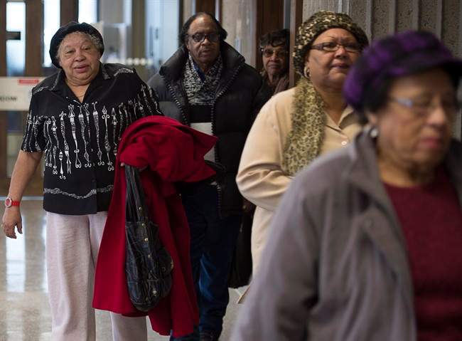 Former residents of Africville and supporters attend Nova Scotia Supreme Court in Halifax on Wednesday, Feb. 25, 2015. The group wants to amend a statement of claim as they attempt to advance a proposed class-action suit against the city seeking compensation for land that was taken by the city in the 1960s. 