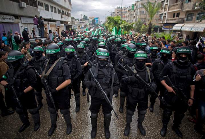 Masked Hamas gunmen display weapons during a rally to commemorate the 27th anniversary of the Hamas militant group, in Gaza City, Dec. 2014.